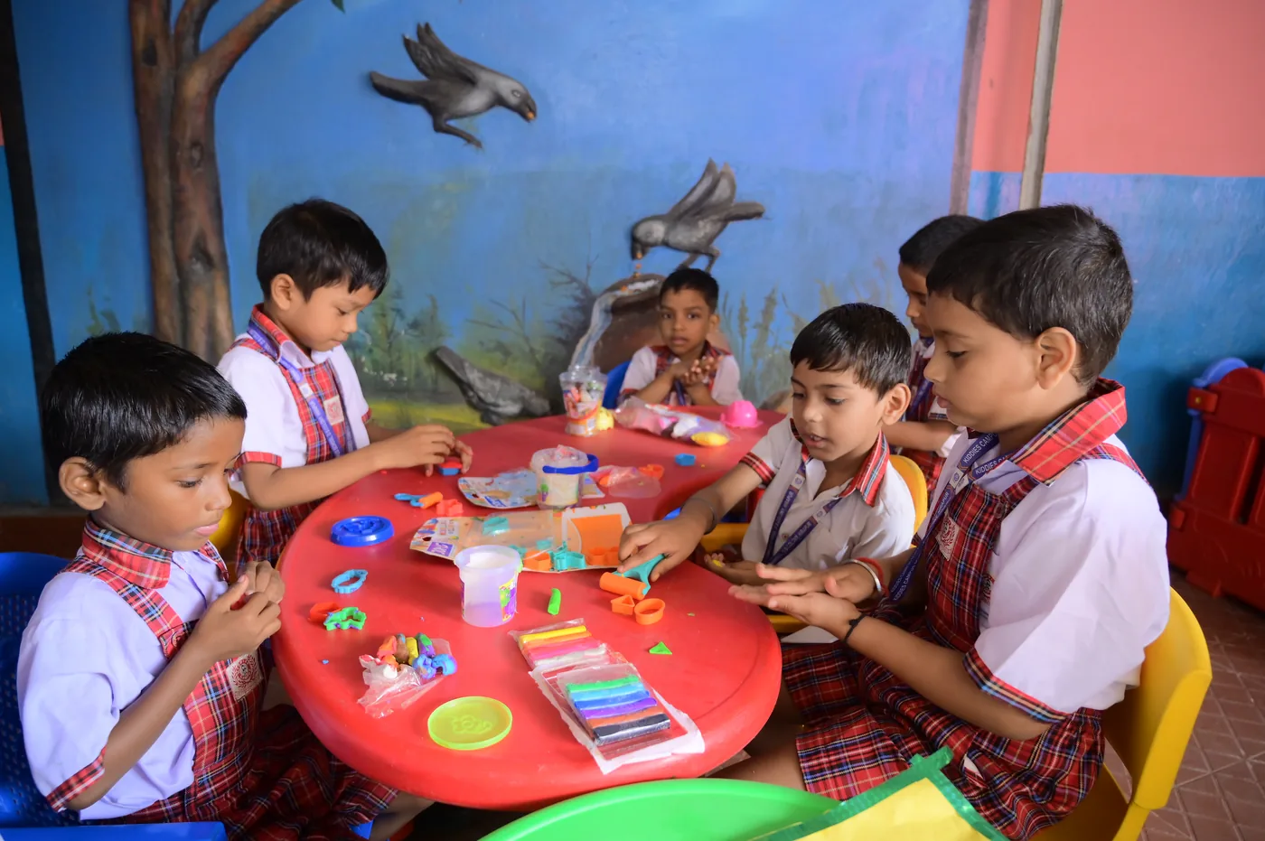 Children shaping coloured clay at an activity table